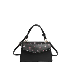 Sweet black crossbody bag with pink cherry floral prints and a knotted handle