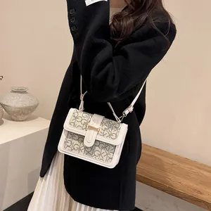 Chic beige crossbody bag with GK monogram pattern and elegant gold buckle for women