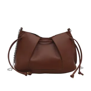 Pleated brown faux leather crescent tote bag with silver chain and drawstring strap
