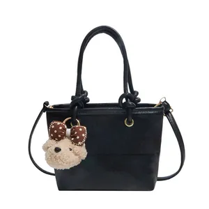 Black suede patchwork bucket bag with knot handle and plush bear charm for women