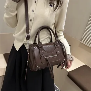 Vintage dark brown Boston bag with silver studs and long fringe zipper details