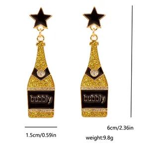 Detail of champagne bottle drop earrings with black star studs and bubbly text