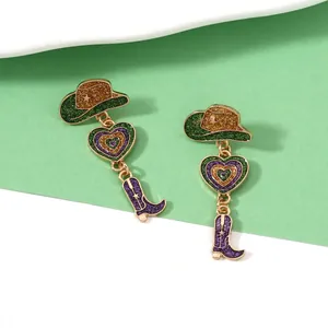 Detail of Western style heart and cowboy boot earrings with purple glitter finish