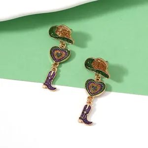Detail of Western cowboy style earrings with glitter hat, heart and boot charms