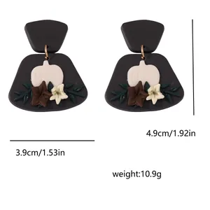Detail view of flower polymer clay earrings showing 4.9cm height and 3.9cm width