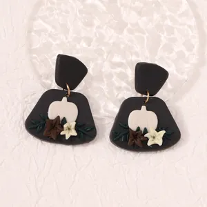 Handmade clay pumpkin and flower earrings with black base for autumn festive style