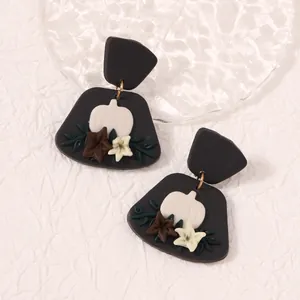 Handmade clay pumpkin drop earrings with floral accents for autumn and Halloween style