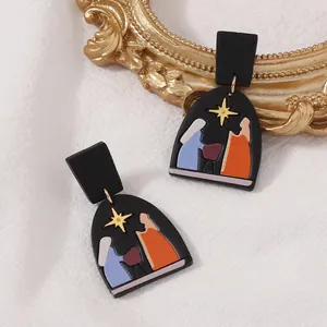 Handgefertigte schwarze Tonohrringe in Bogenform mit goldenem Stern und Krippenmotiv