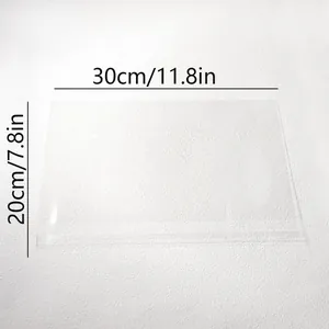 Vista detallada de placa acrílica transparente de 30x20cm con líneas de medida