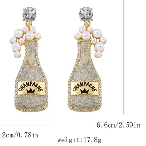 Detail view of champagne bottle earrings with pearls, dimensions 2cm x 6.6cm and 17.8g weight