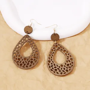 Bohemian walnut brown hollow wood teardrop earrings with intricate geometric cutout pattern