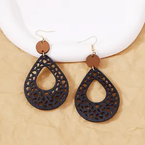 Bohemian retro wood teardrop earrings with cutout leopard pattern and gold hooks