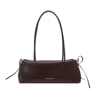 Minimalist chocolate brown baguette shoulder bag with ribbon bow details and long straps