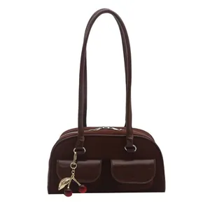 Retro chocolate suede shoulder bag with leather panels and cherry leaf pendant