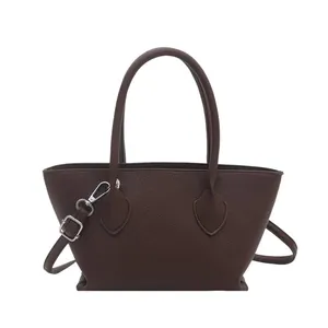 Dark brown leather bucket bag with lychee texture and silver hardware in main view