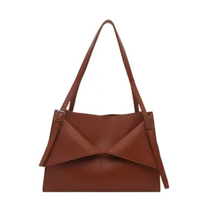 Caramel brown leather shoulder tote bag with geometric envelope fold design and metal buckles