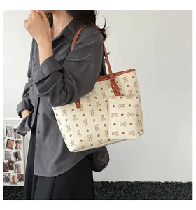 Detail of printed tote bag with cartoon bear pattern and detachable mini pouch