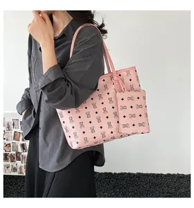 Pink monogram tote bag with matching pouch featuring bear patterns and pebble texture
