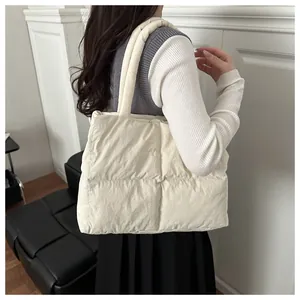 Detail of off-white quilted puff tote bag with soft padding and thick shoulder straps