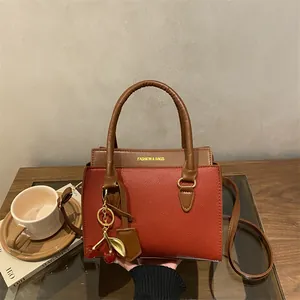 Retro red and brown patchwork handbag with metal cherry charm and long shoulder strap
