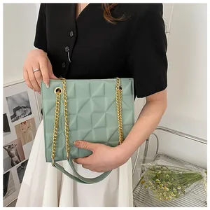 Chic mint green crossbody bag with geometric quilted pattern and gold chain strap detail