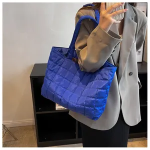 Blue quilted tote bag featuring large capacity and diamond stitch design for women