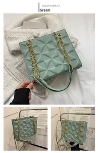 Detail of sage green crossbody bag with 3D geometric texture and gold chain strap