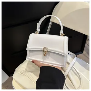 Close-up of white PU leather crossbody bag with elegant gold ring metal buckle and handle