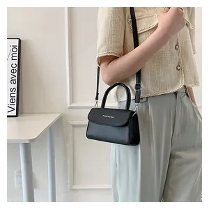 Fashionable black faux leather crossbody bag with top handle and white text print detail