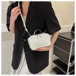 White faux leather crossbody bag with dual zippers and fashion engraving shown on model
