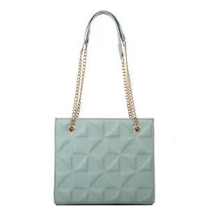 Minimalist light green crossbody bag with geometric quilting and gold chain strap