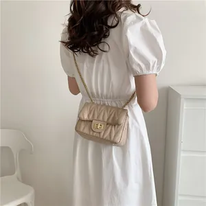 Beige quilted diamond pattern shoulder bag with gold chain strap and metal lock closure