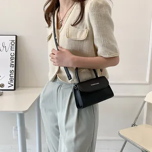Minimalist black PU leather small square bag with fashion text and adjustable crossbody strap