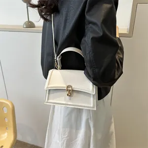 Chic cream leather crossbody bag with gold buckle ring, shown on model for daily wear