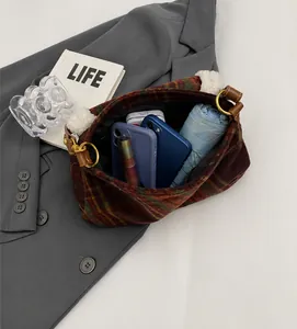 Internal capacity of retro plaid shoulder bag showing storage for phone and umbrella