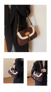 Detail of vintage plaid shoulder bag featuring wool trim and golden metal logo plate