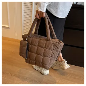 Detail of coffee brown quilted tote bag with detachable pouch and soft padded texture