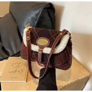 Close-up of retro color-block plaid handbag with fuzzy faux fur trim and gold metal logo