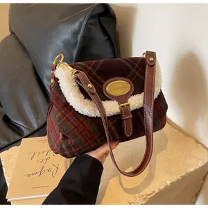 Detailed close-up of retro plaid shoulder bag with soft faux shearling trim and metal logo