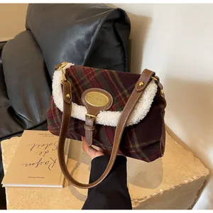 Detailed view of vintage plaid underarm bag with plush faux fur trim and gold hardware