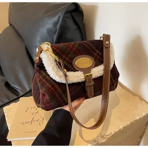 Detail of vintage plaid shoulder bag with red-green pattern and shearling trim