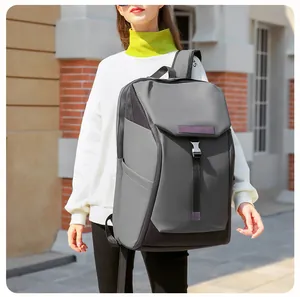 Outdoor shot of a waterproof grey and black travel backpack with metal buckle detail