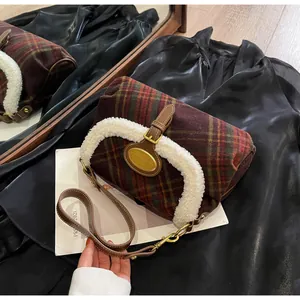 Close-up of retro plaid crossbody bag with sherpa trim and golden metal nameplate