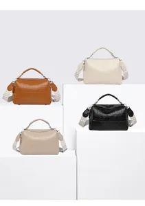 Detail view of four textured crocodile pattern crossbody pillow bags in various colors