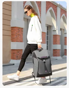 Waterproof grey travel backpack showing spacious side pocket and buckle closure details