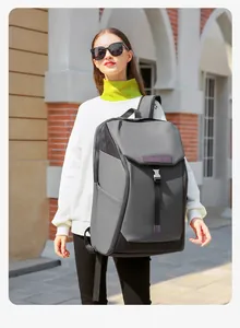 Close-up of waterproof grey backpack featuring metal buckle closure and stylish wide straps