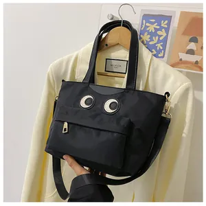Detail der schwarzen Nylontasche mit Comic-Augen und funktioneller Reißverschlusstasche