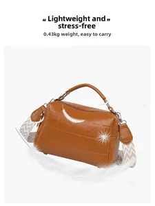 Detail of caramel crocodile embossed Boston bag with wide jacquard strap weighing only 0.43kg