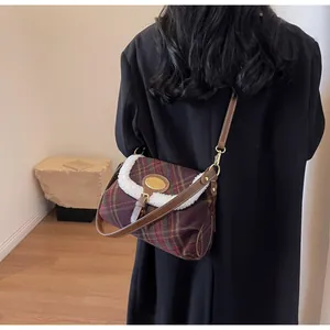 Detail of vintage plaid tweed shoulder bag with white faux fur trim and gold buckle