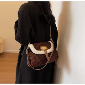Close-up of retro plaid crossbody bag with sheepskin trim and brown leather strap